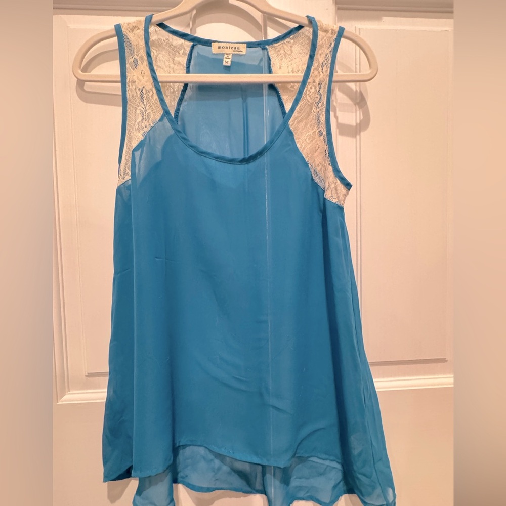 Be festival ready with this sheer teal and lace tank from the 2000s.